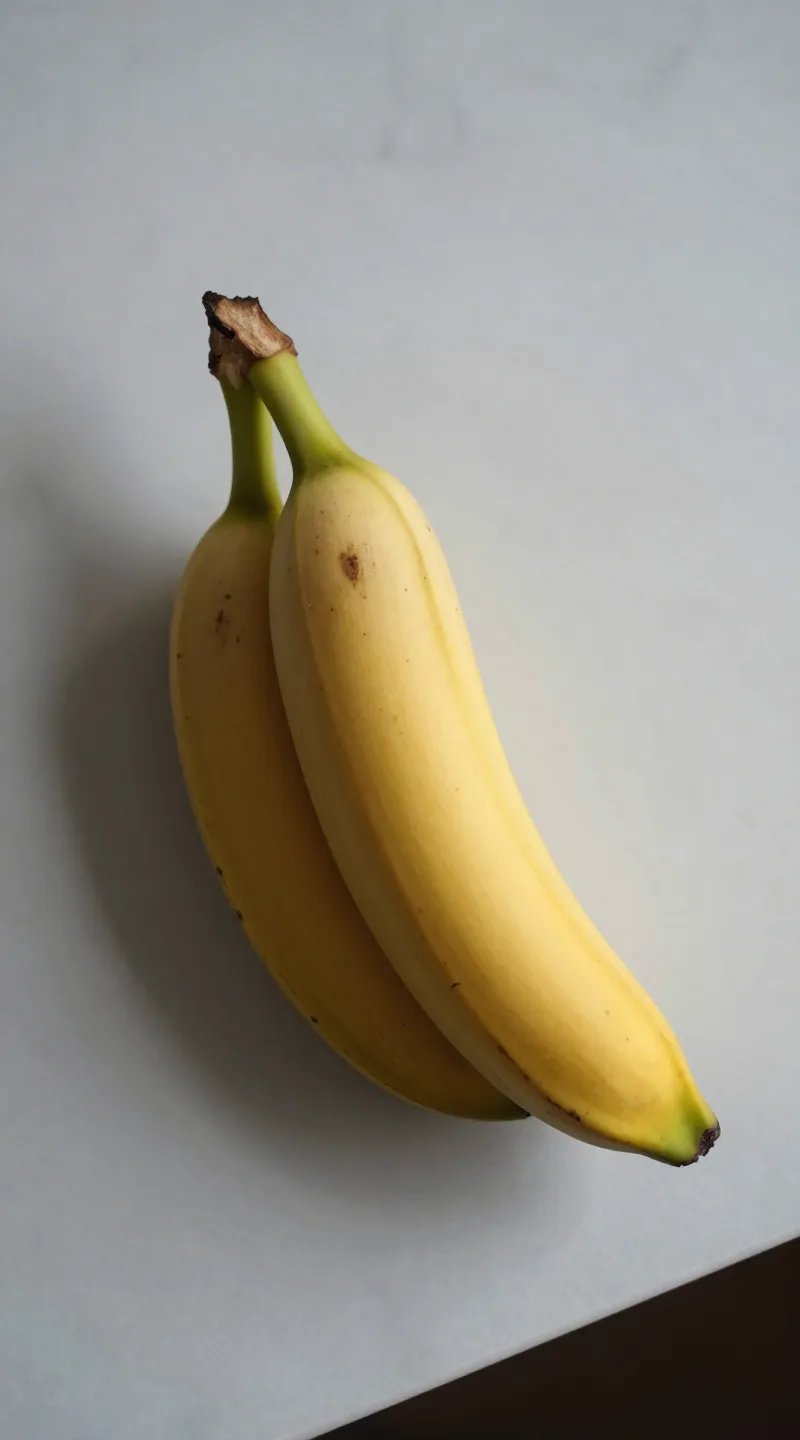 single ripe banana on marble countertop, soft daylight