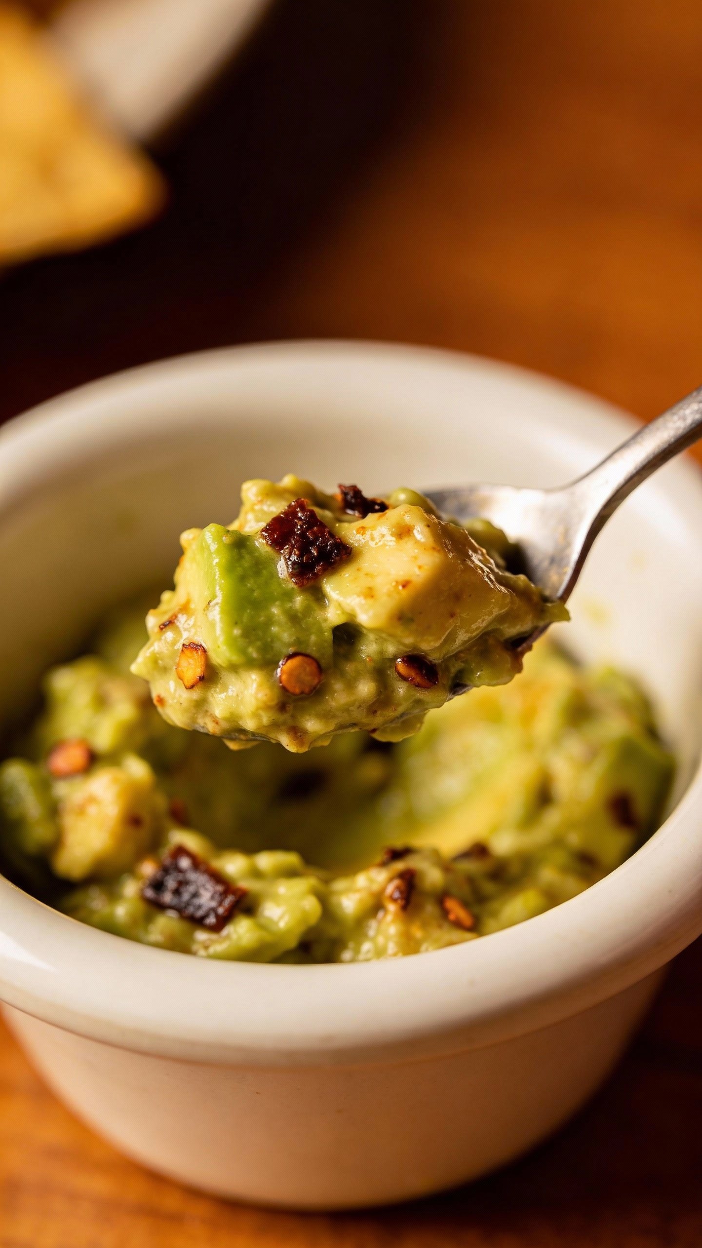 spoonful of chunky chipotle guacamole in small bowl