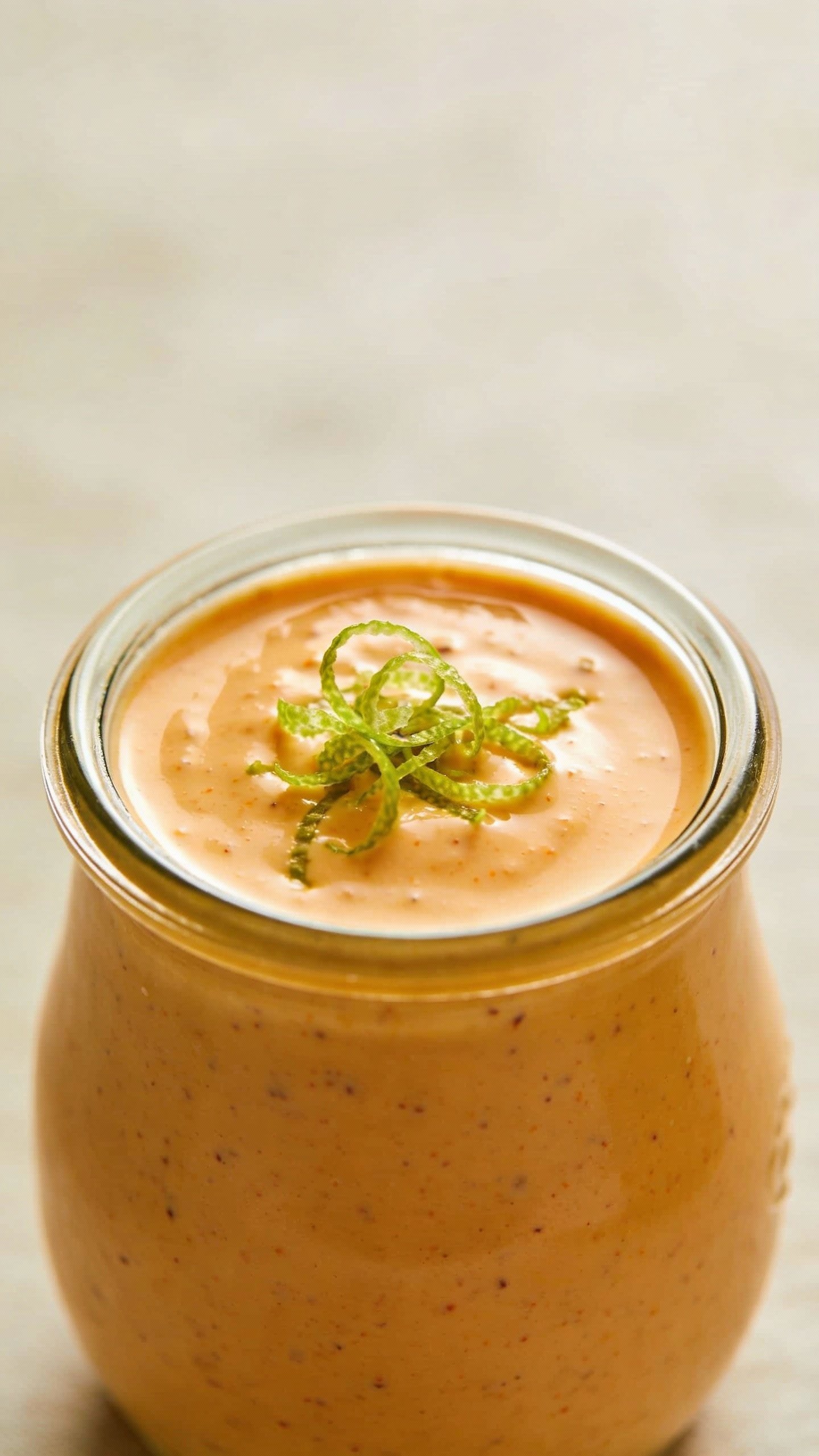 small jar of creamy zesty fajita dressing, lime zest garnish