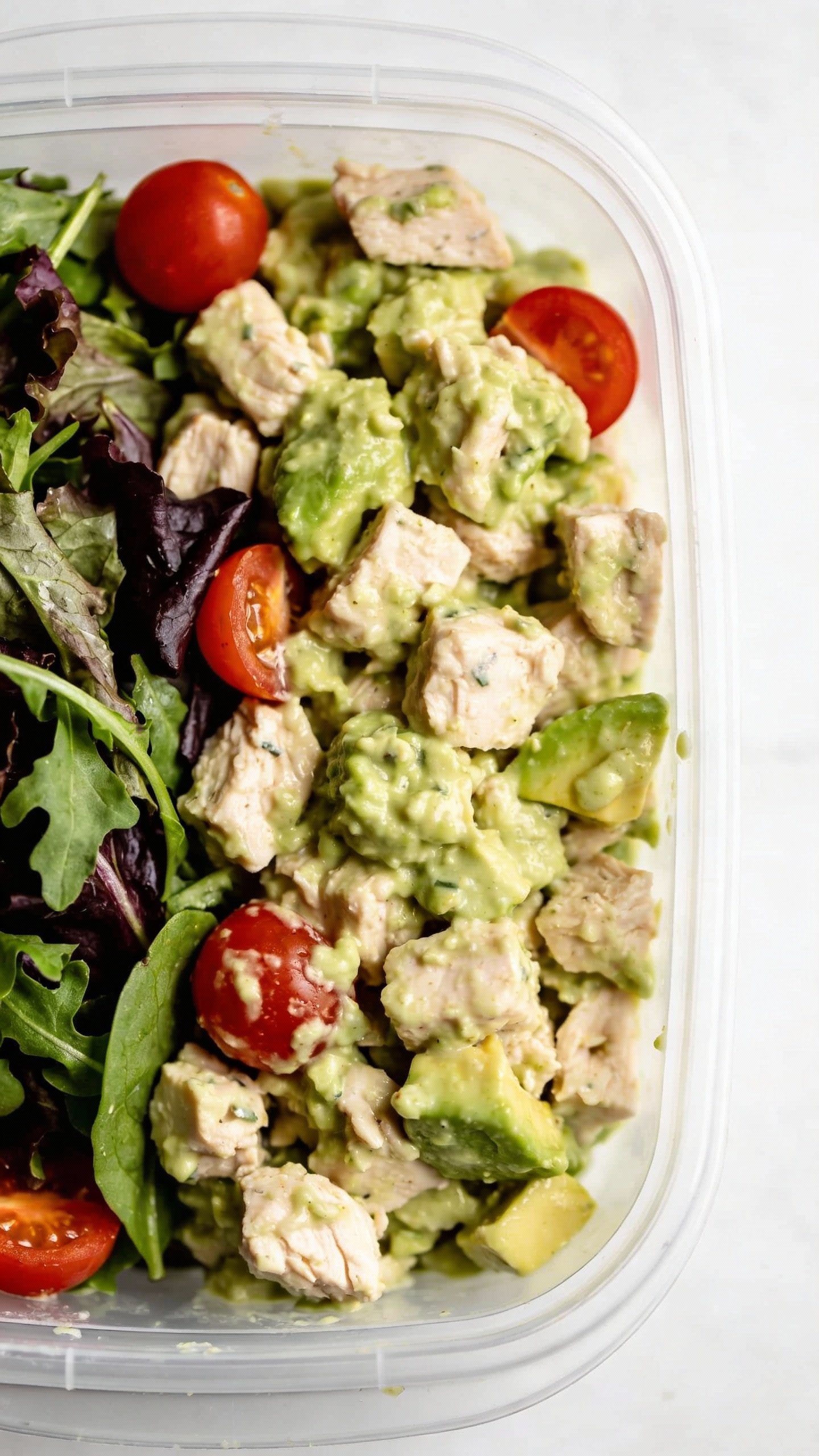 Single meal-prep container of avocado chicken salad, top-down