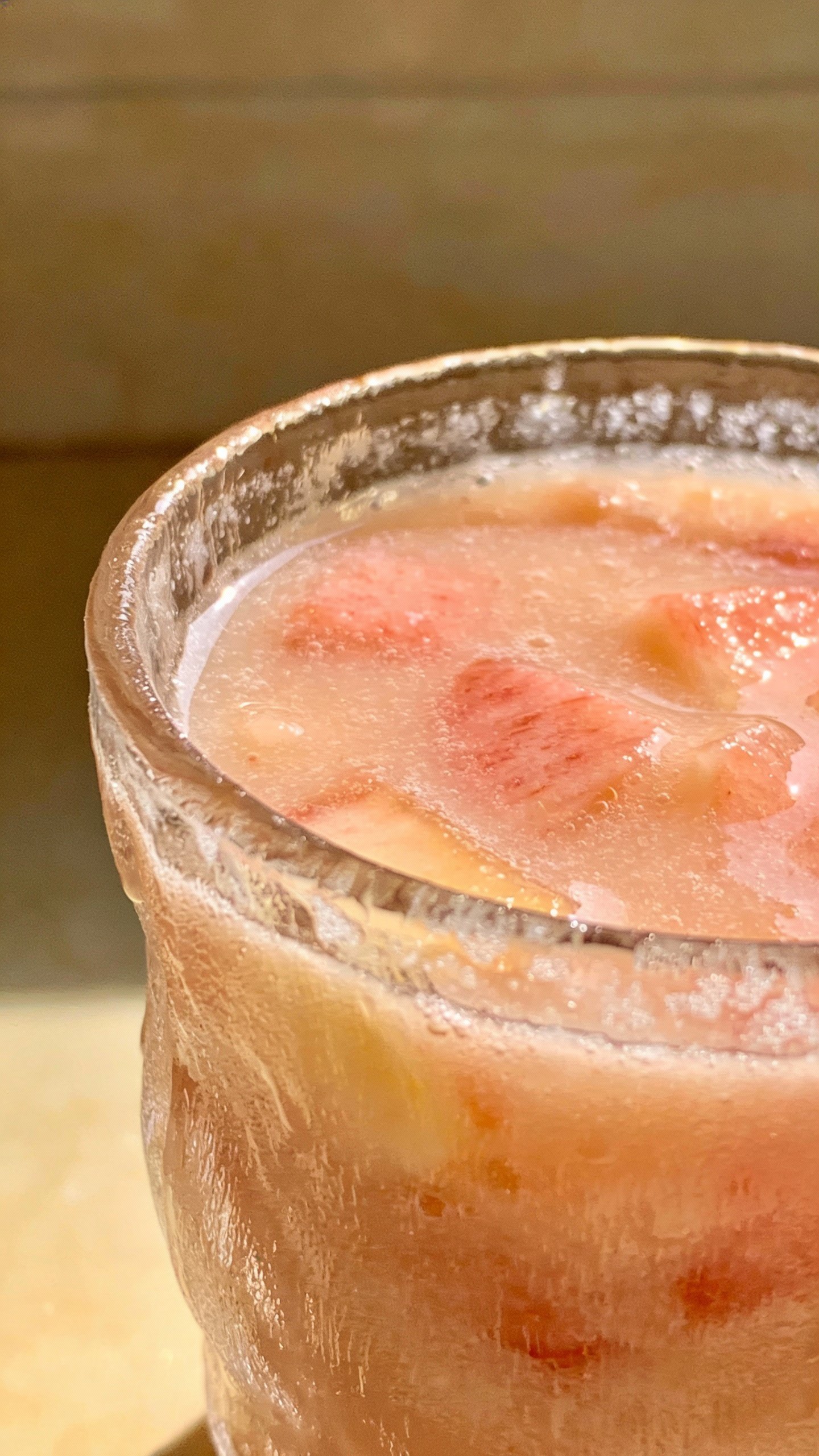 closeup honey peach smoothie in clear glass, frosty condensation