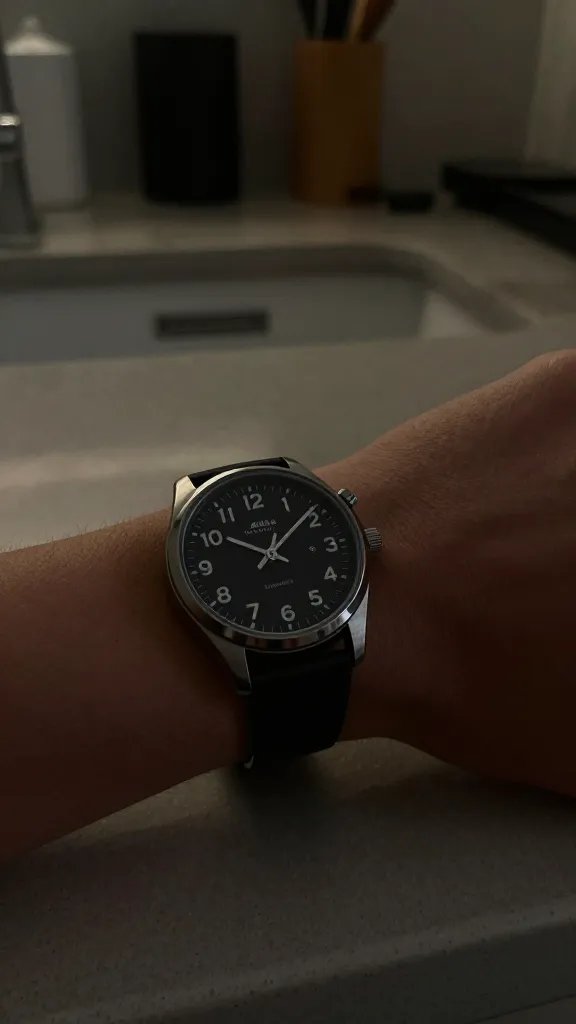 wristwatch showing 10 p.m., dim kitchen counter closeup