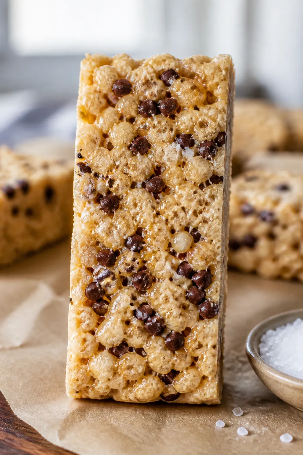 Close-up detail shot: A freshly sliced High Protein Low Carb Rice Krispie Treat bar held upright on 