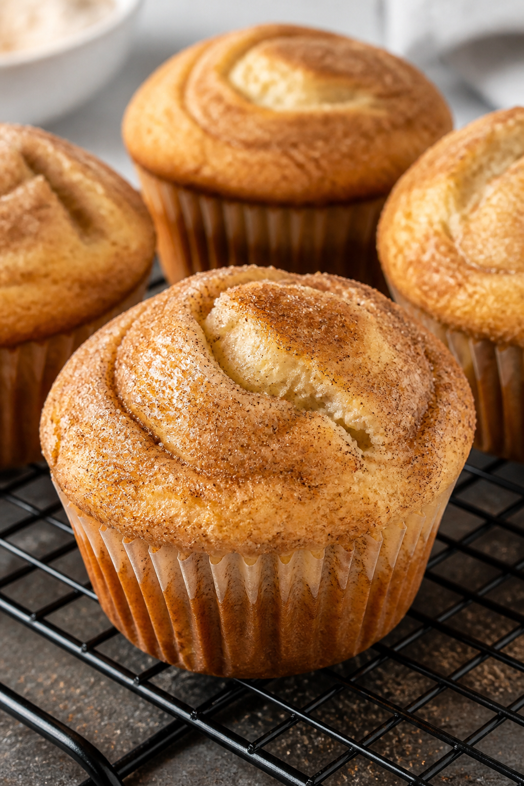 Close-up detail shot of freshly baked snickerdoodle muffins just out of the oven, warm and steaming