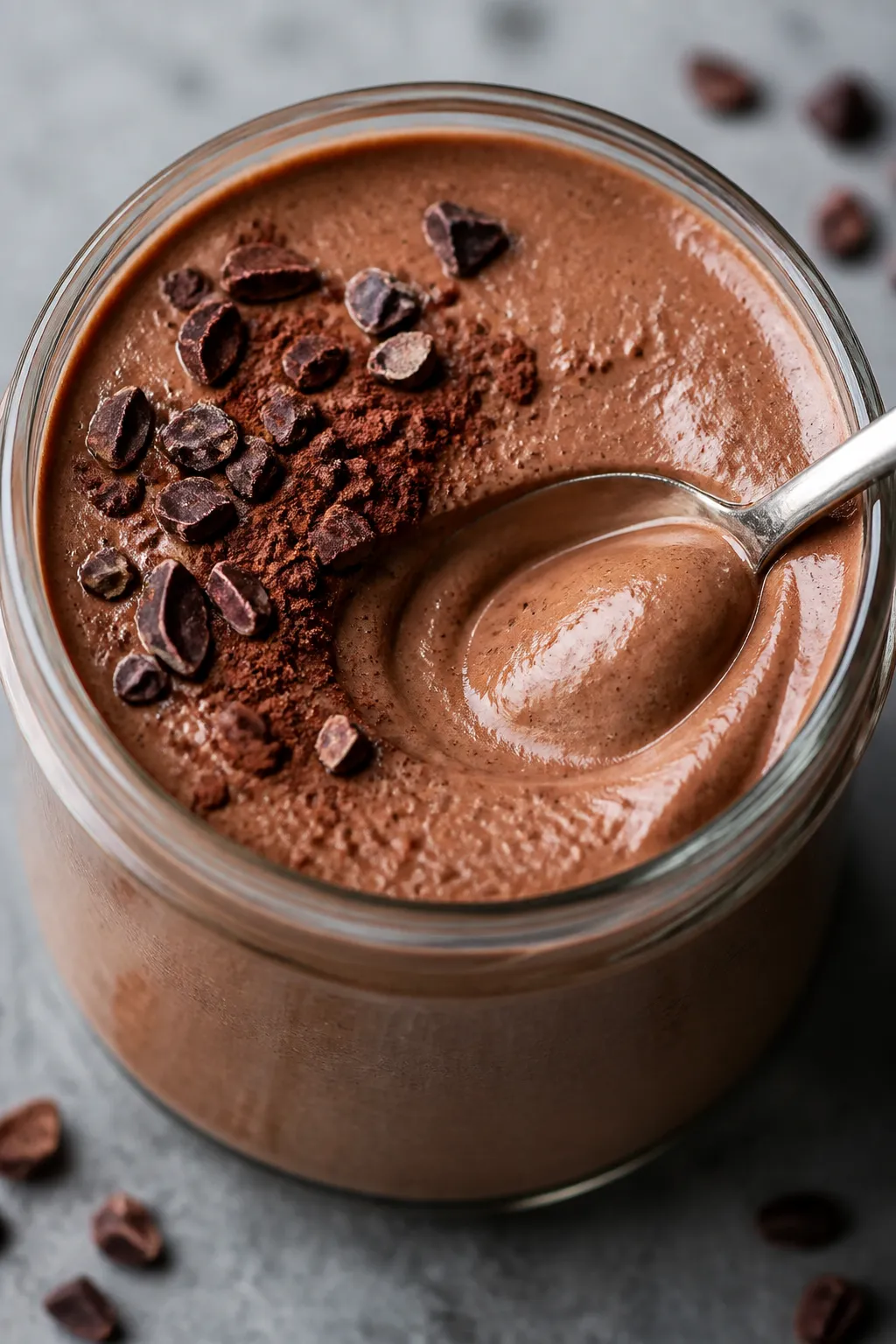 Close-up detail: Silky cottage cheese chocolate protein pudding just after blending, spoon swirl rev