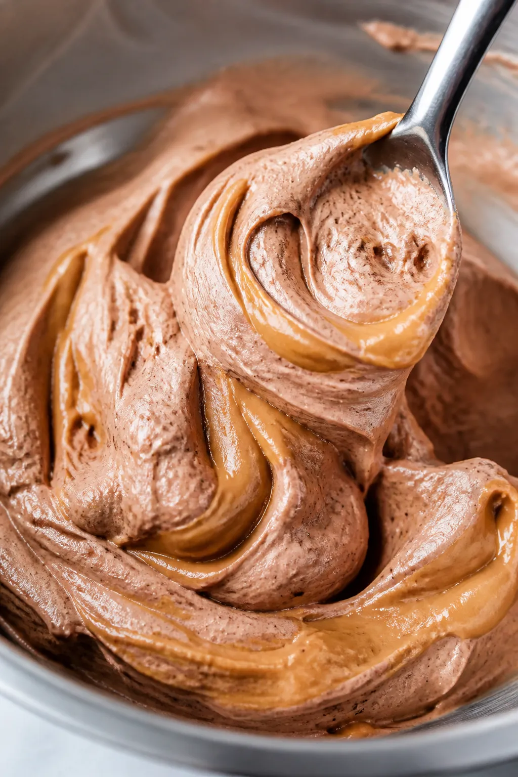 Close-up detail: Silky peanut butter cup mousse just after whipping, spoon creating soft peaks in a