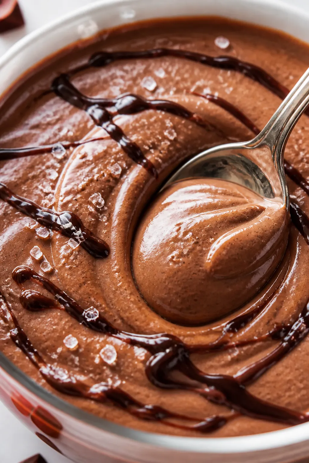 Close-up detail: Ultra-creamy peanut butter cup pudding just after blending, spoon creating a silky 