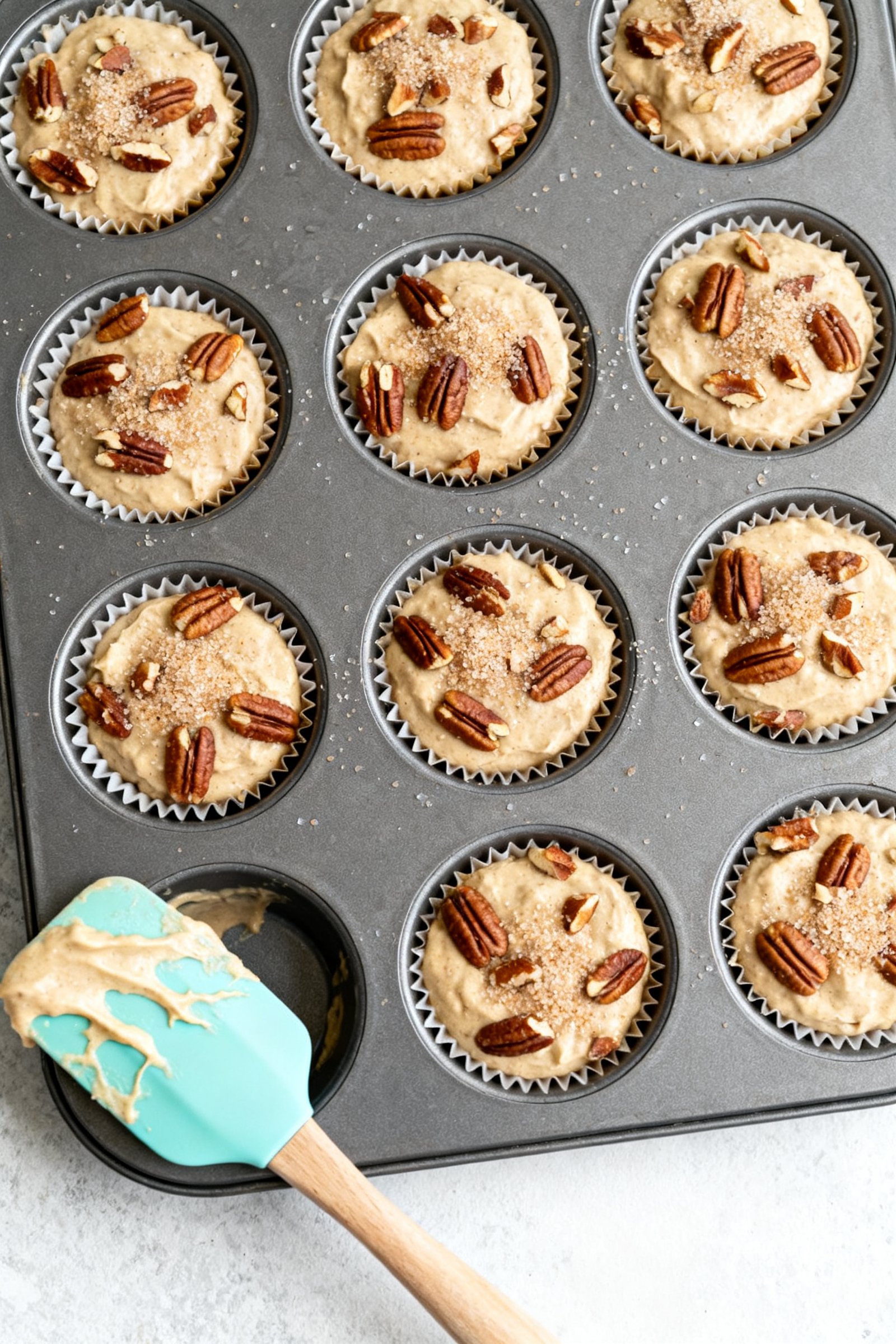 Cooking process: Overhead shot of a 12-cup muffin pan just filled 3/4 full with the combined batter,