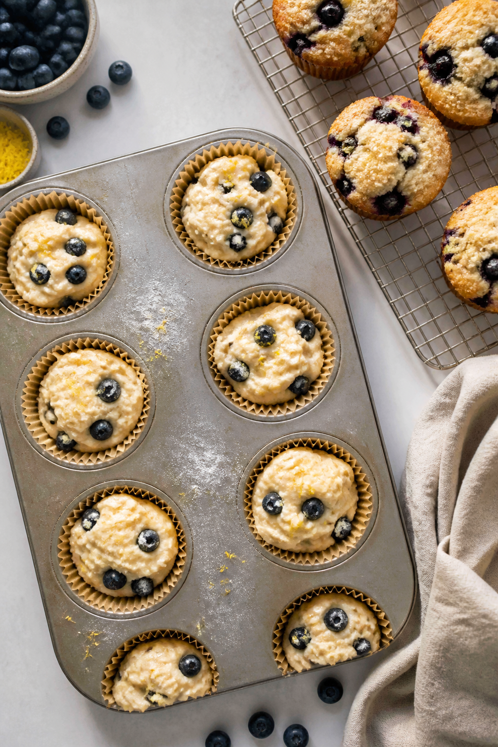 Cooking process: Overhead shot of a lined muffin tin filled 3/4 full with thick, scoopable batter al