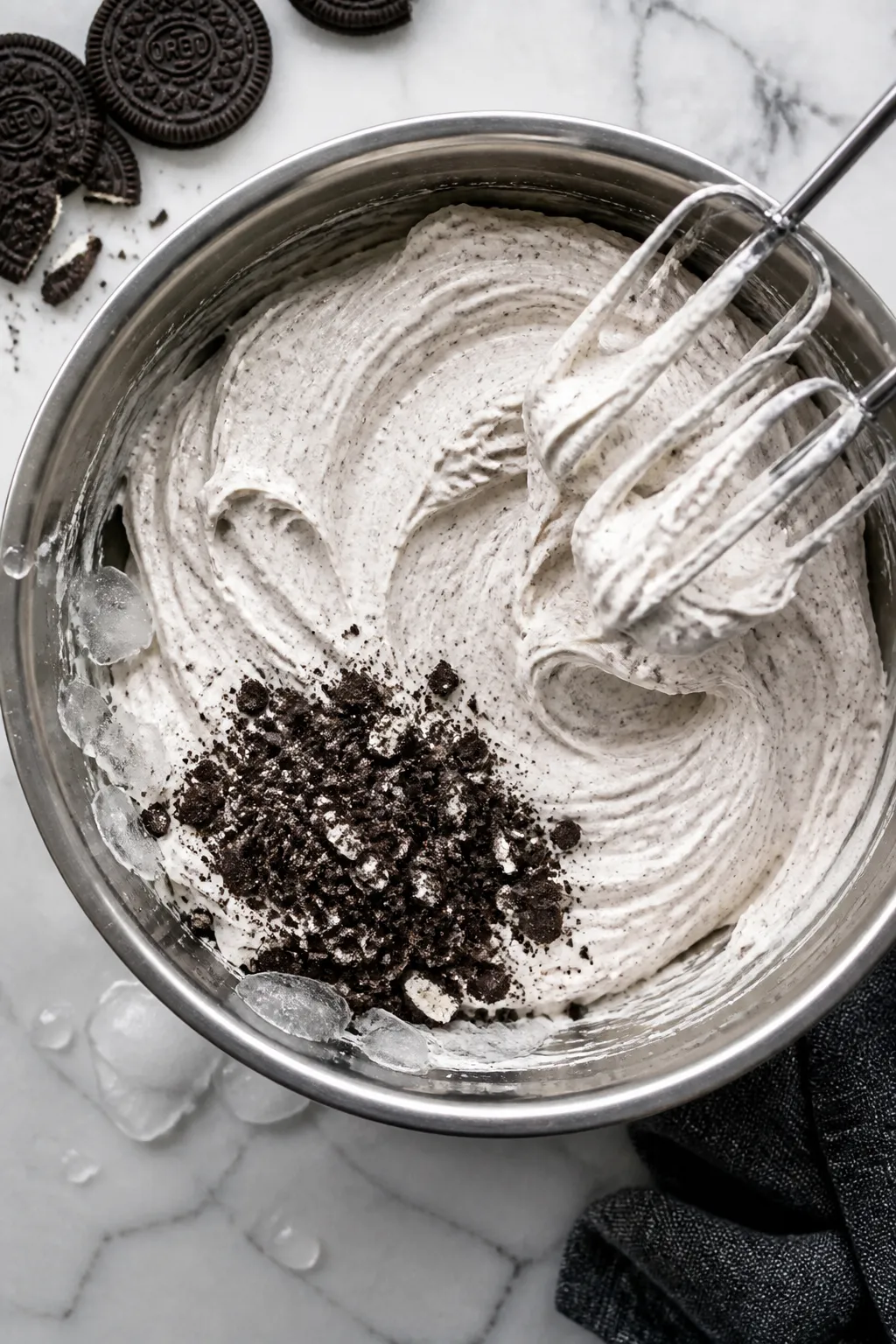Cooking process: Overhead shot of freshly whipped, voluminous Oreo protein fluff in a chilled stainl
