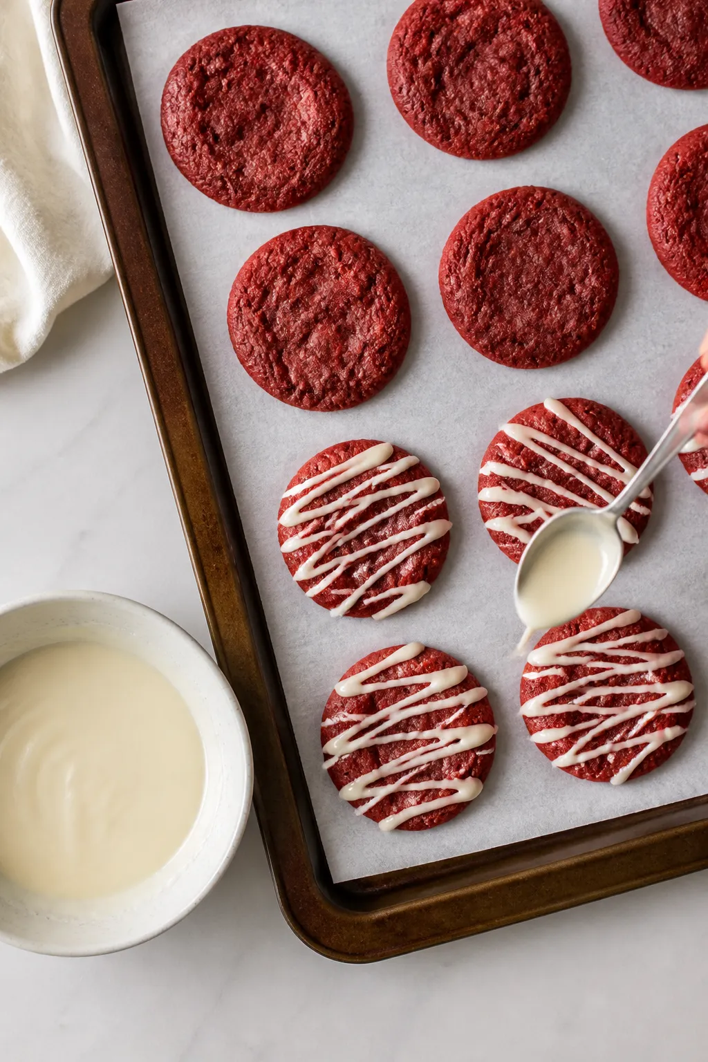Cooking process: Overhead shot of shaped, slightly flattened red velvet protein cookie mounds on a p