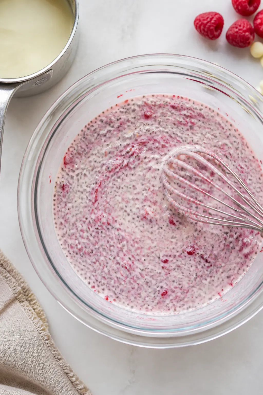 Cooking process: Overhead shot of the just-mixed chia pudding base in a clear mixing bowl after the 