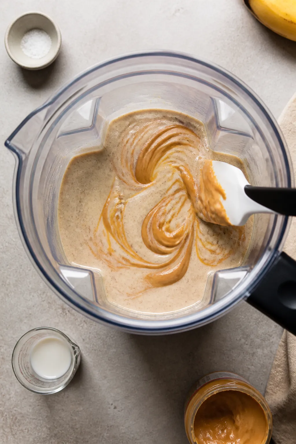 Cooking process: Overhead shot of the pudding base mid-prep in a blender jar, already fully blended 