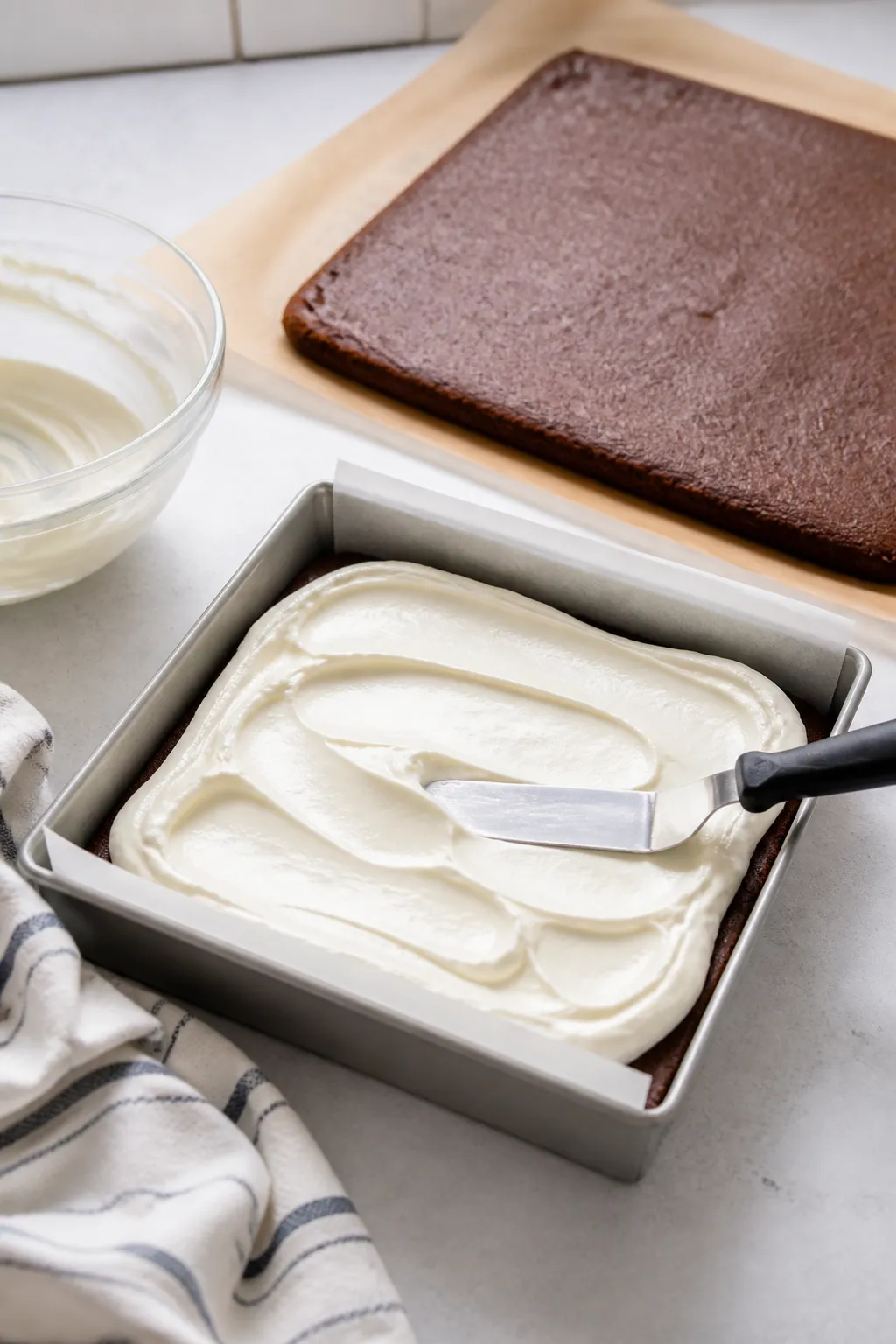 Cooking process shot: The bottom cookie layer par-baked and cooled in the lined pan while the silky 