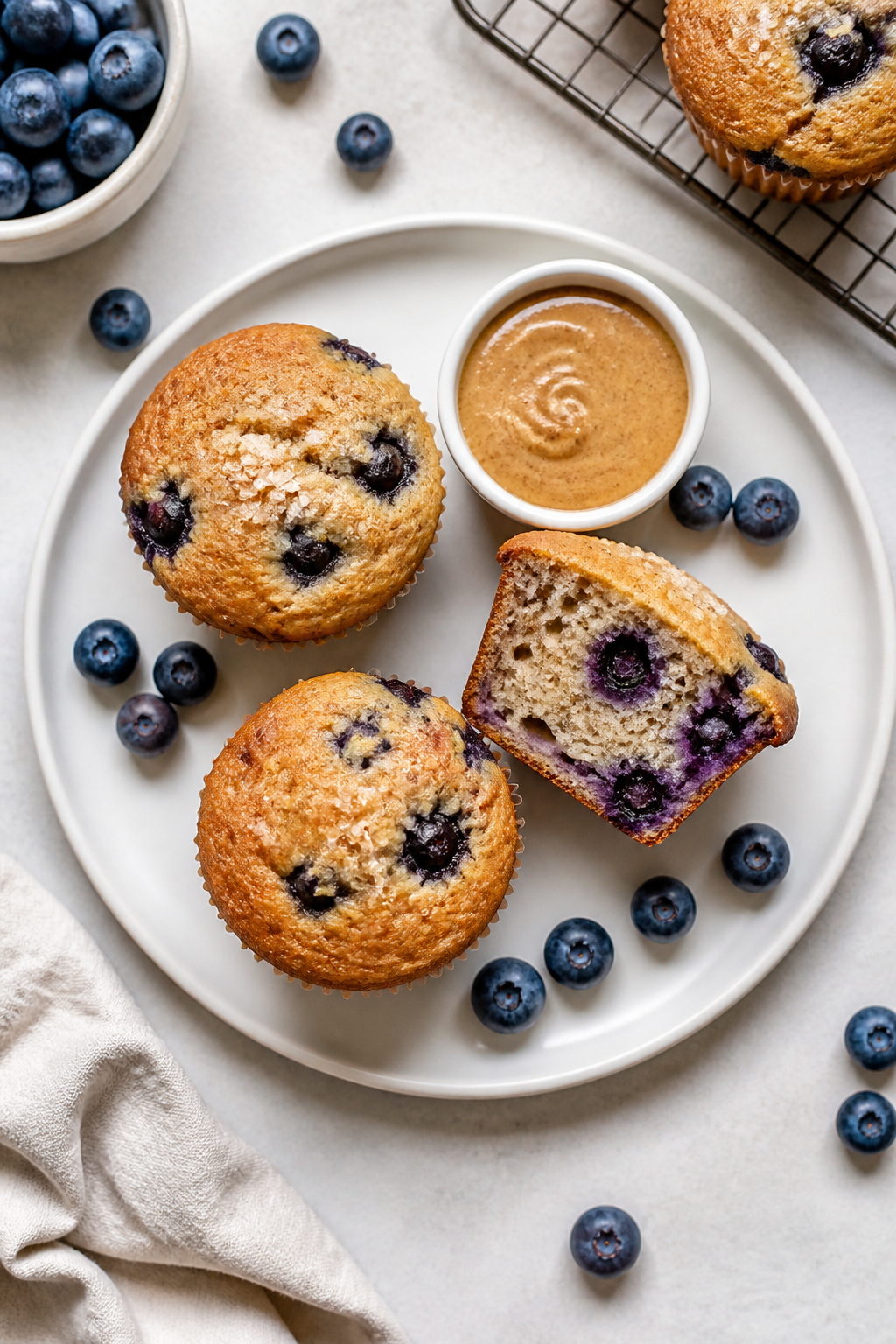 Final dish presentation: Restaurant-quality plate-up of blueberry protein muffins on a matte white p