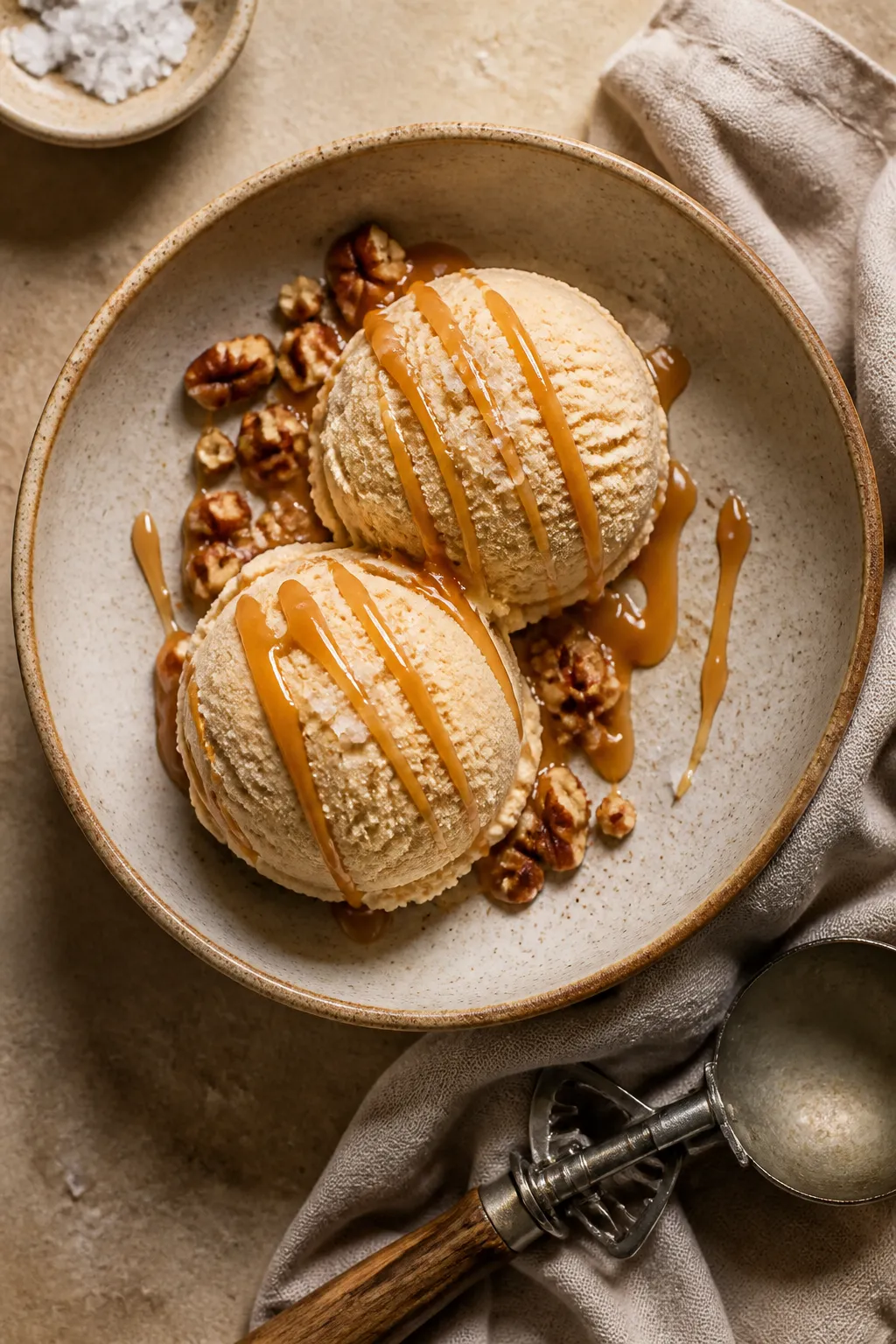 Final dish presentation: Restaurant-quality plated salted caramel protein ice cream—two rounded sc