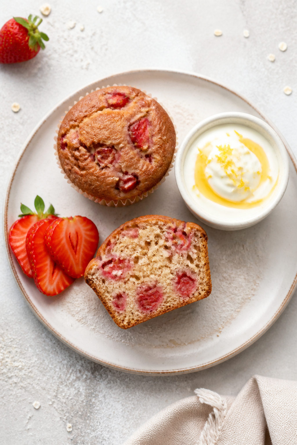 Final dish presentation: Restaurant-quality plating of two strawberry protein muffins on a white sto