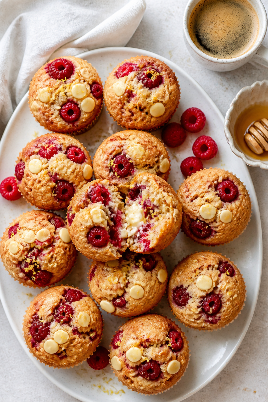 Final dish, tasty top view: Overhead hero shot of 9–12 Raspberry White Chocolate Protein Muffins a