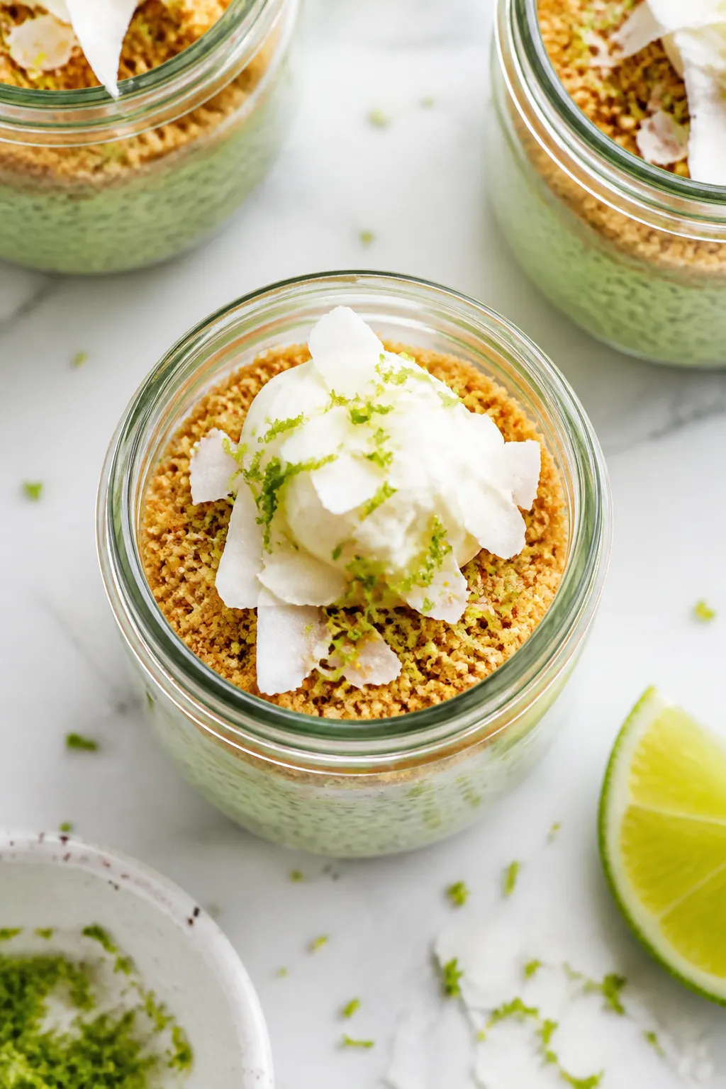 Final plated hero shot: Beautifully assembled High Protein Key Lime Pie Chia Pudding in a clear glas