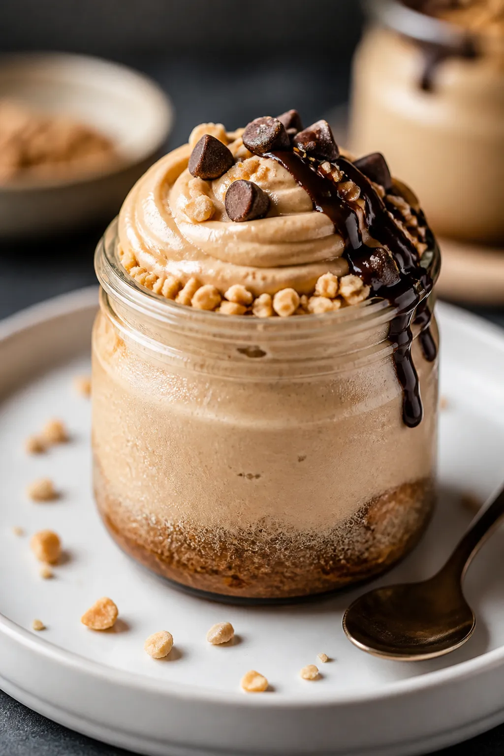 Final presentation — Hero close-up of a single chilled peanut butter cheesecake jar ready to serve
