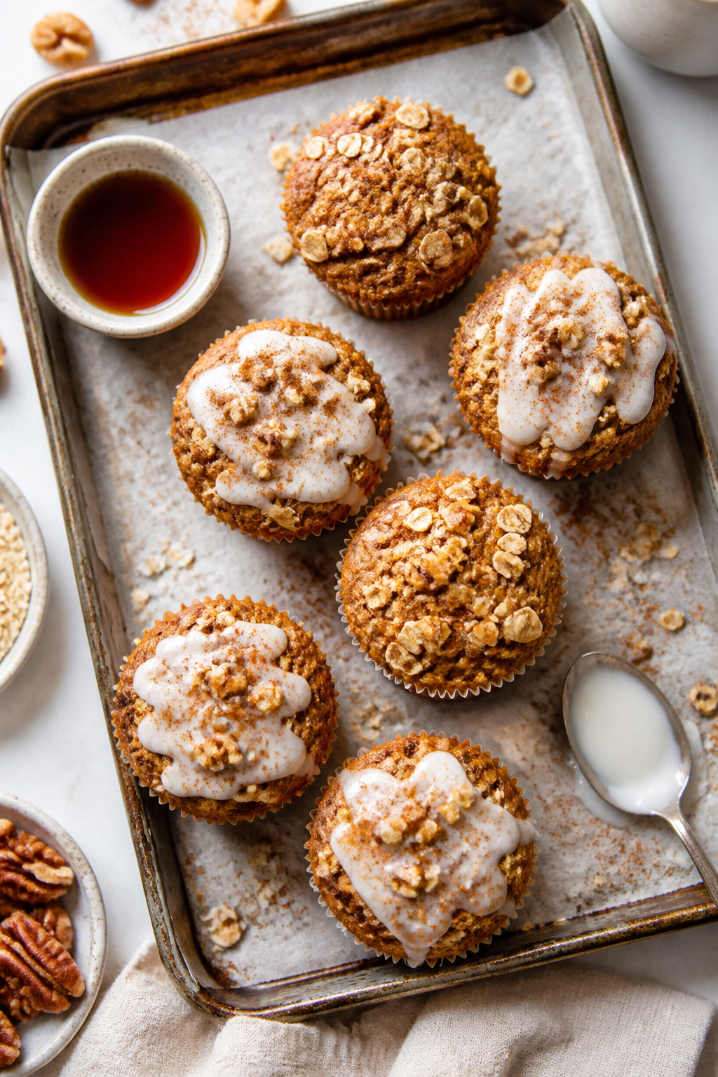 Overhead “tasty top view” of a breakfast spread featuring 6–8 carrot cake protein muffins on p