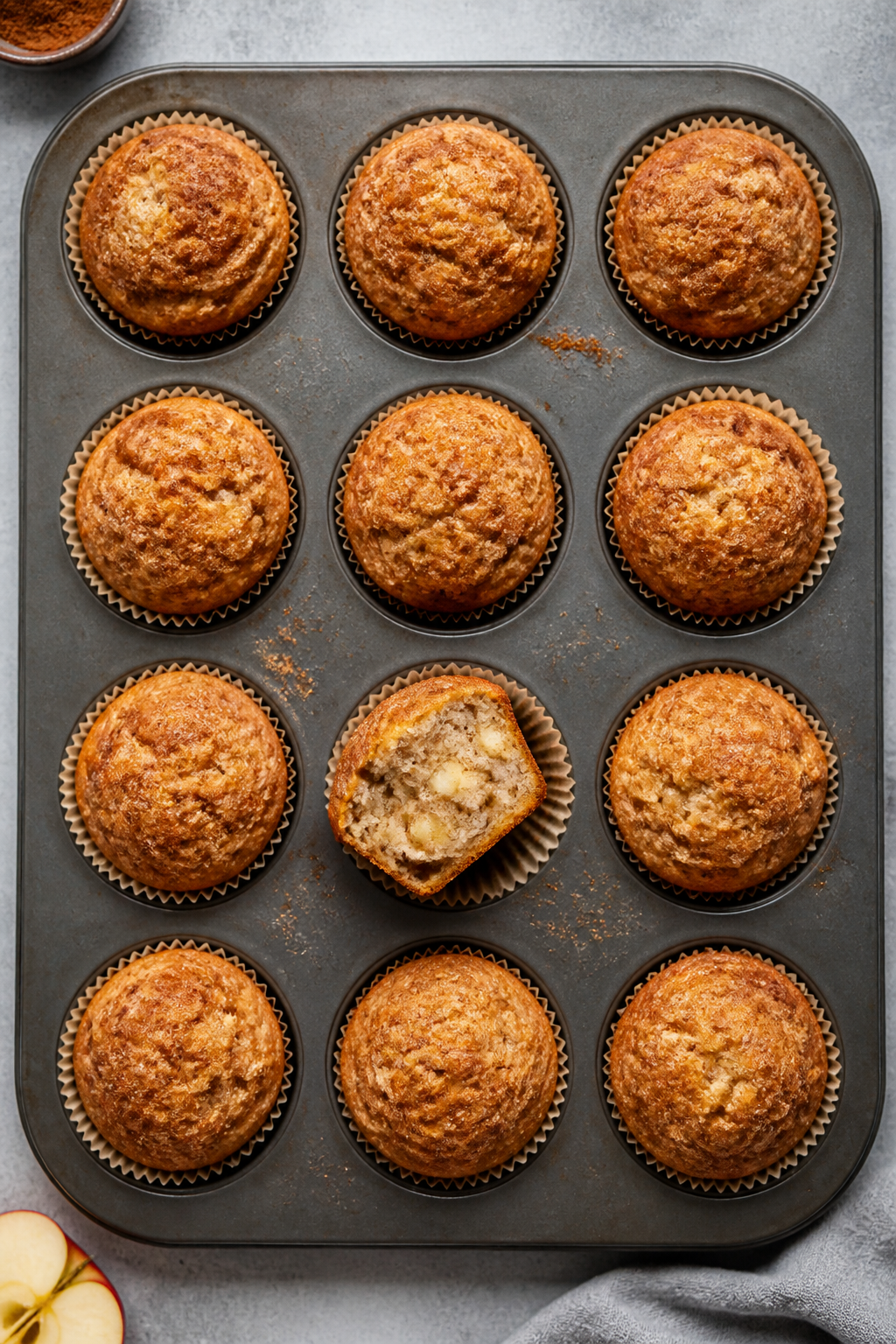 Tasty top view: Overhead shot of 12 apple pie muffins in paper liners arranged in a muffin tin, each