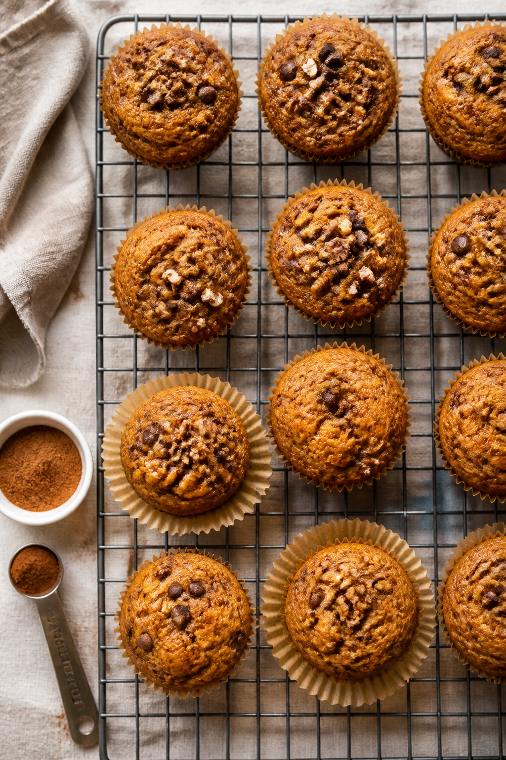 Tasty top view: Overhead shot of a cooling rack filled with protein pumpkin muffins arranged in a lo