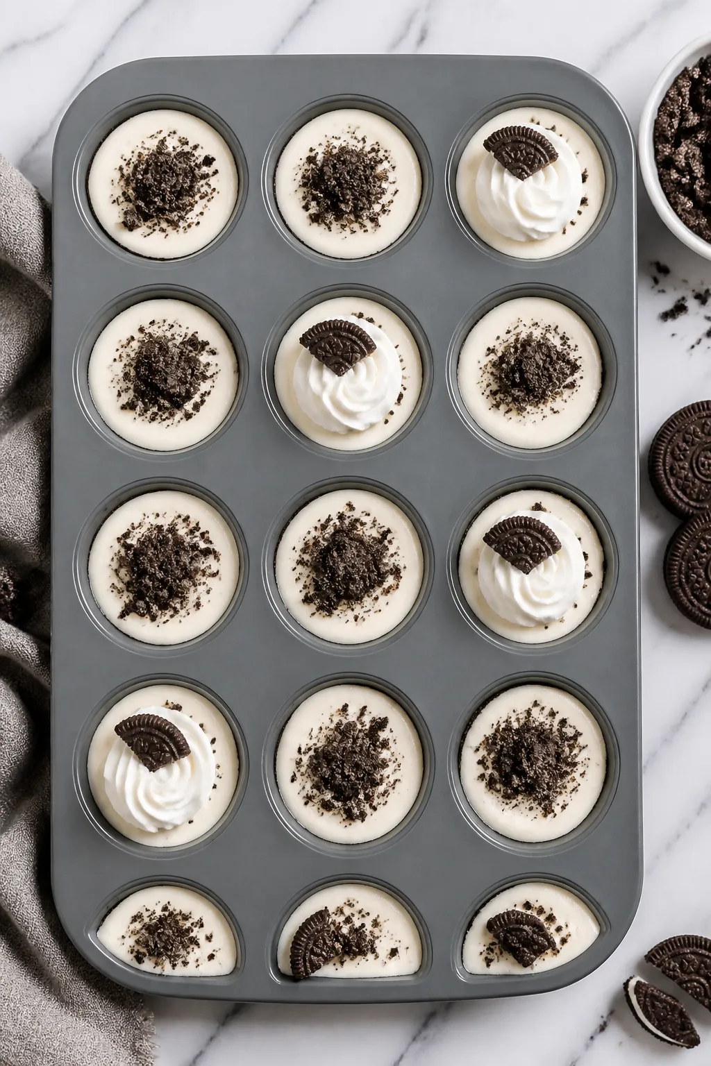 Tasty top view: Overhead shot of a silicone muffin pan filled with portioned Oreo cheesecake cups, s