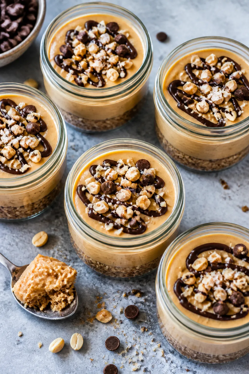 Tasty top view — Overhead shot of assembled peanut butter cheesecake jars: neat layers with a gold
