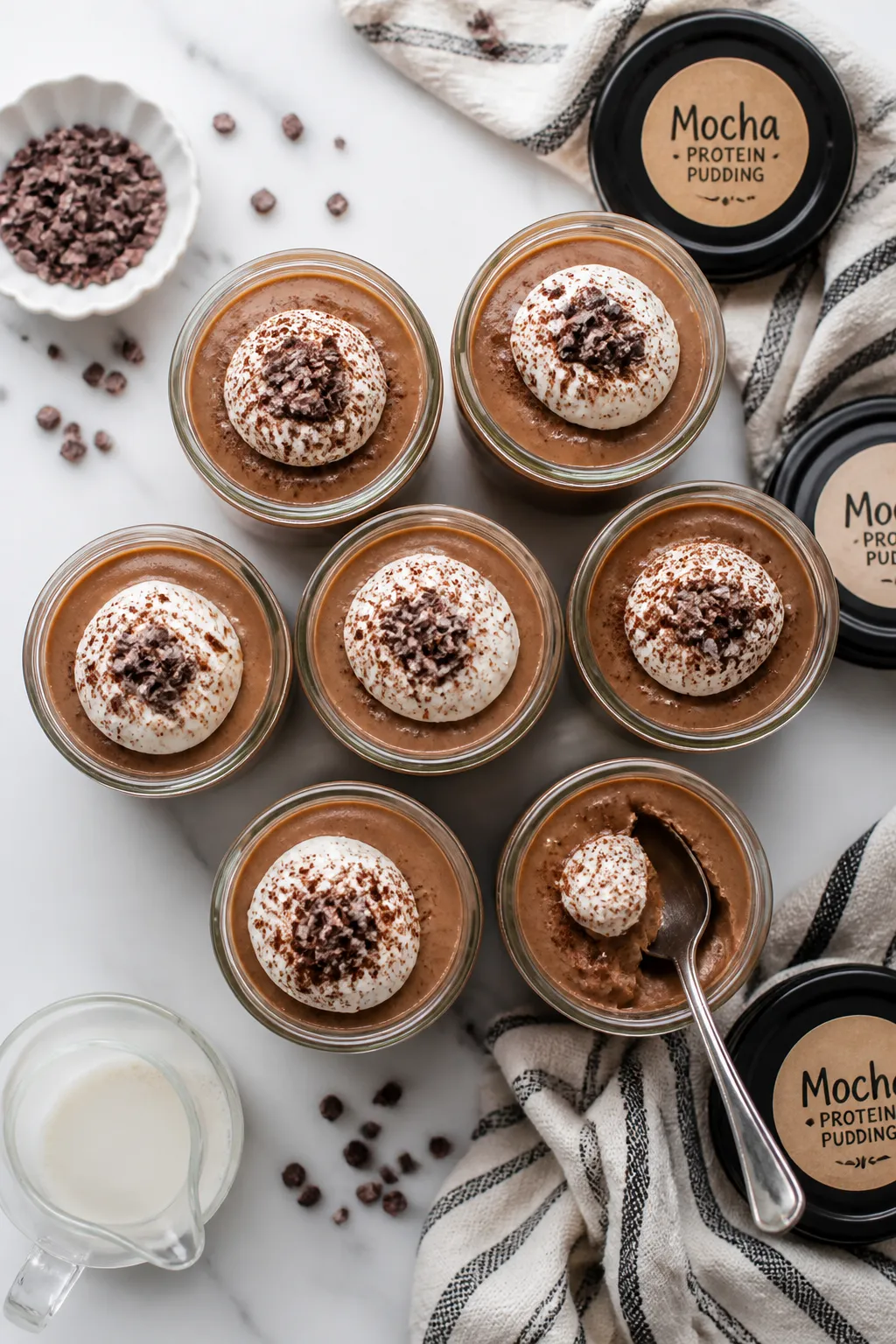 Tasty top view: Overhead shot of chilled mocha protein pudding portioned into small glass jars for m