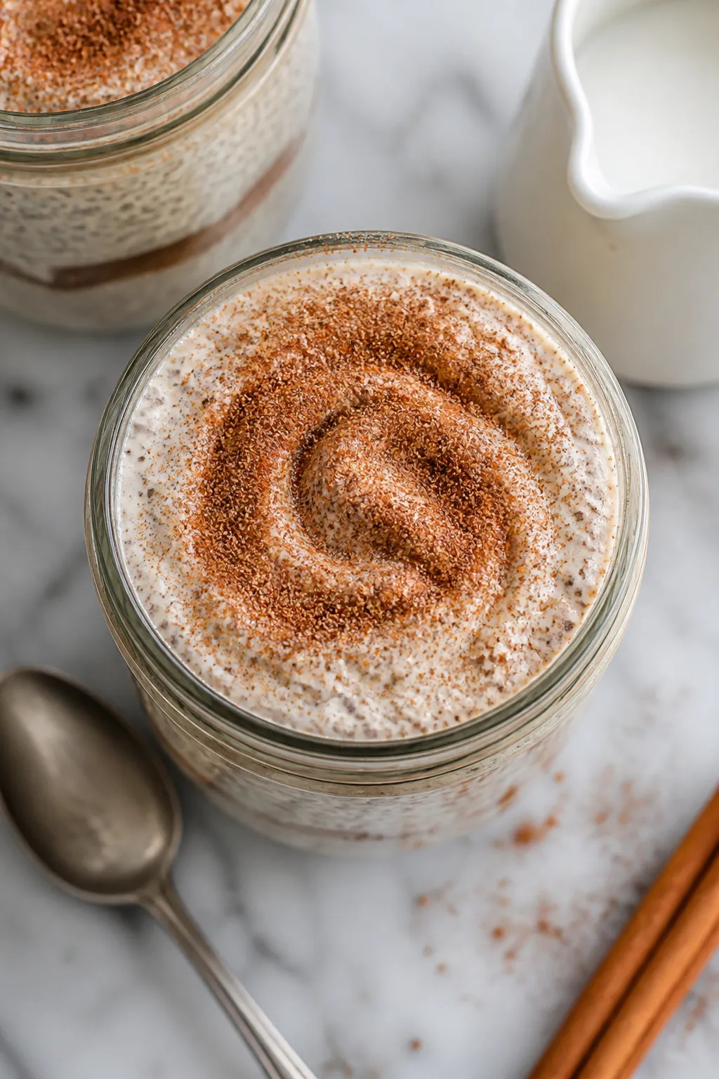 Tasty top view: Overhead shot of finished High Protein Snickerdoodle Chia Pudding in a clear glass j