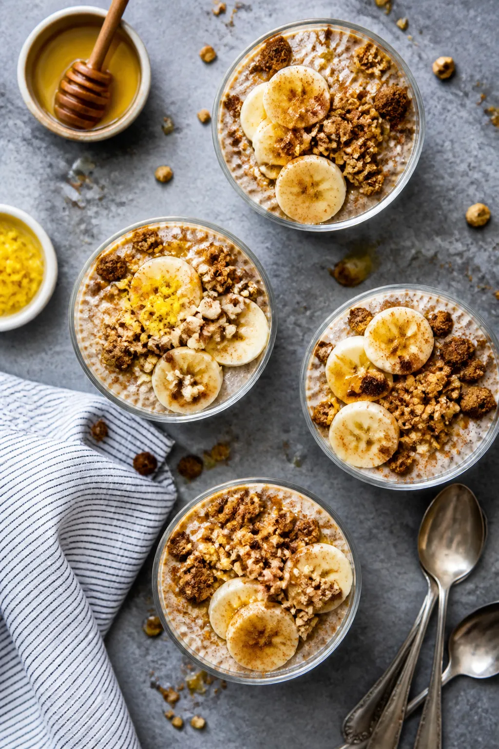 Tasty top view: Overhead shot of four assembled protein pudding cups arranged on a cool gray slab; e