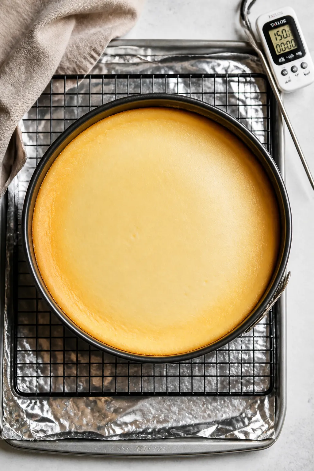 Tasty top view: Overhead shot of the fully baked cheesecake just out of the water bath, set edges wi