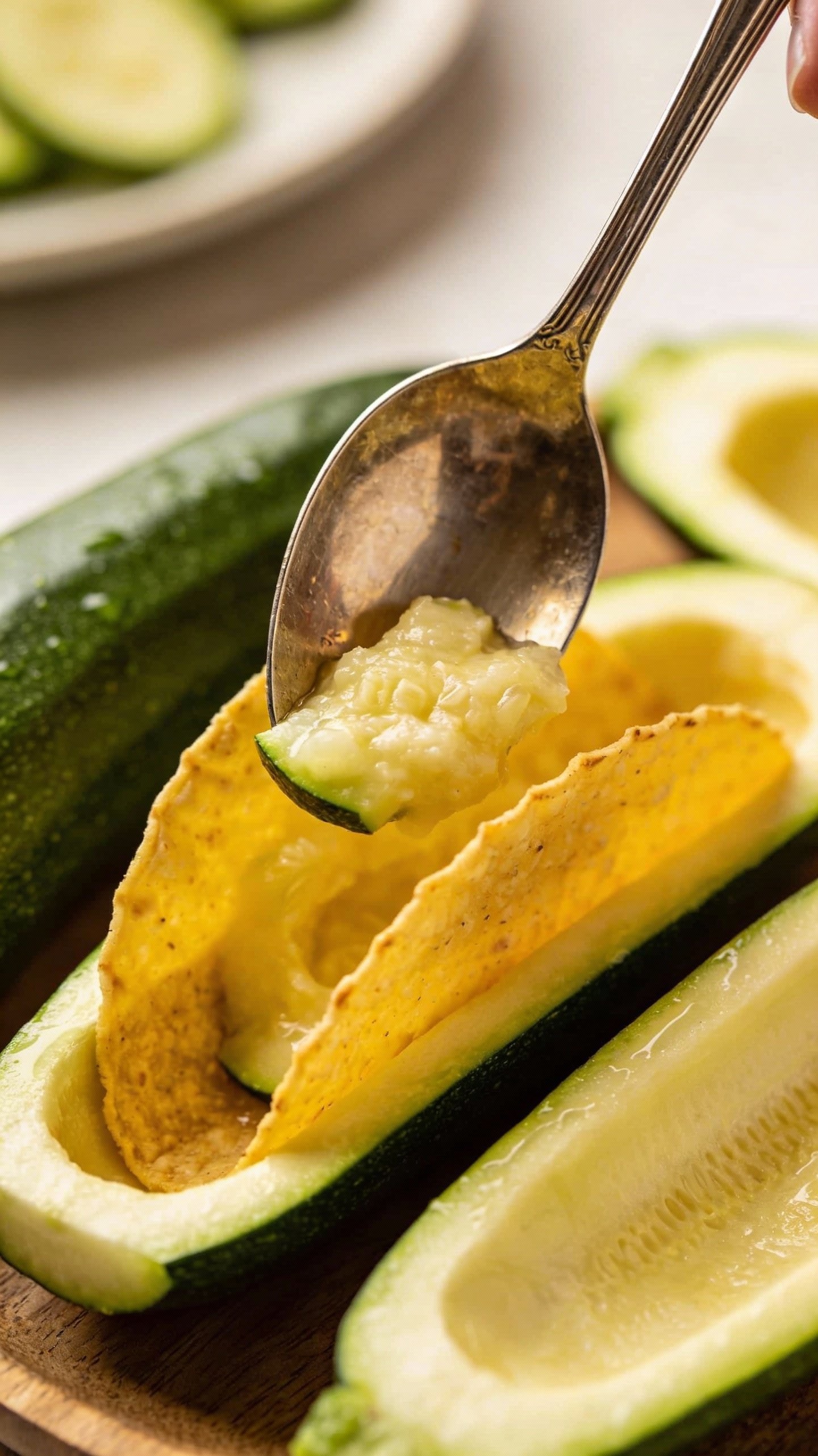 spoon scooping zucchini center for taco boat