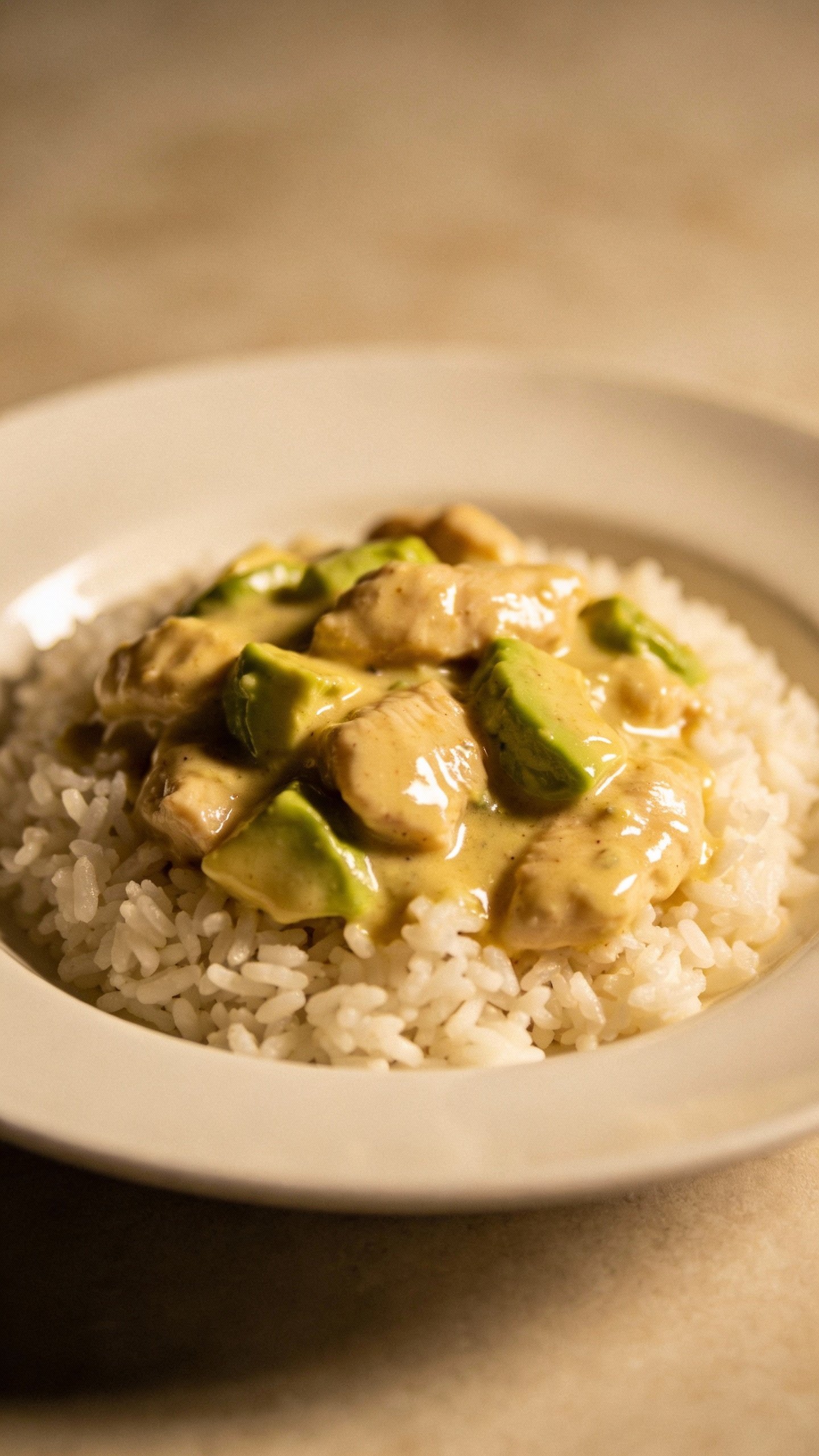 single plate of creamy avocado chicken over white rice