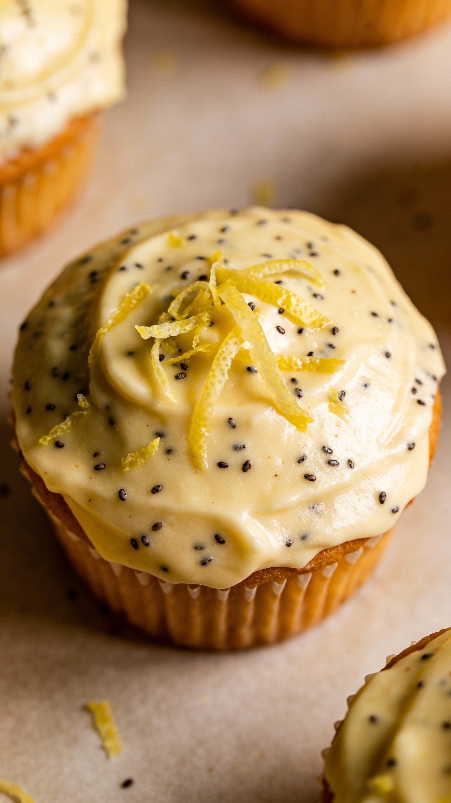 overhead frosted muffin with poppy lemon zest, matte backdrop