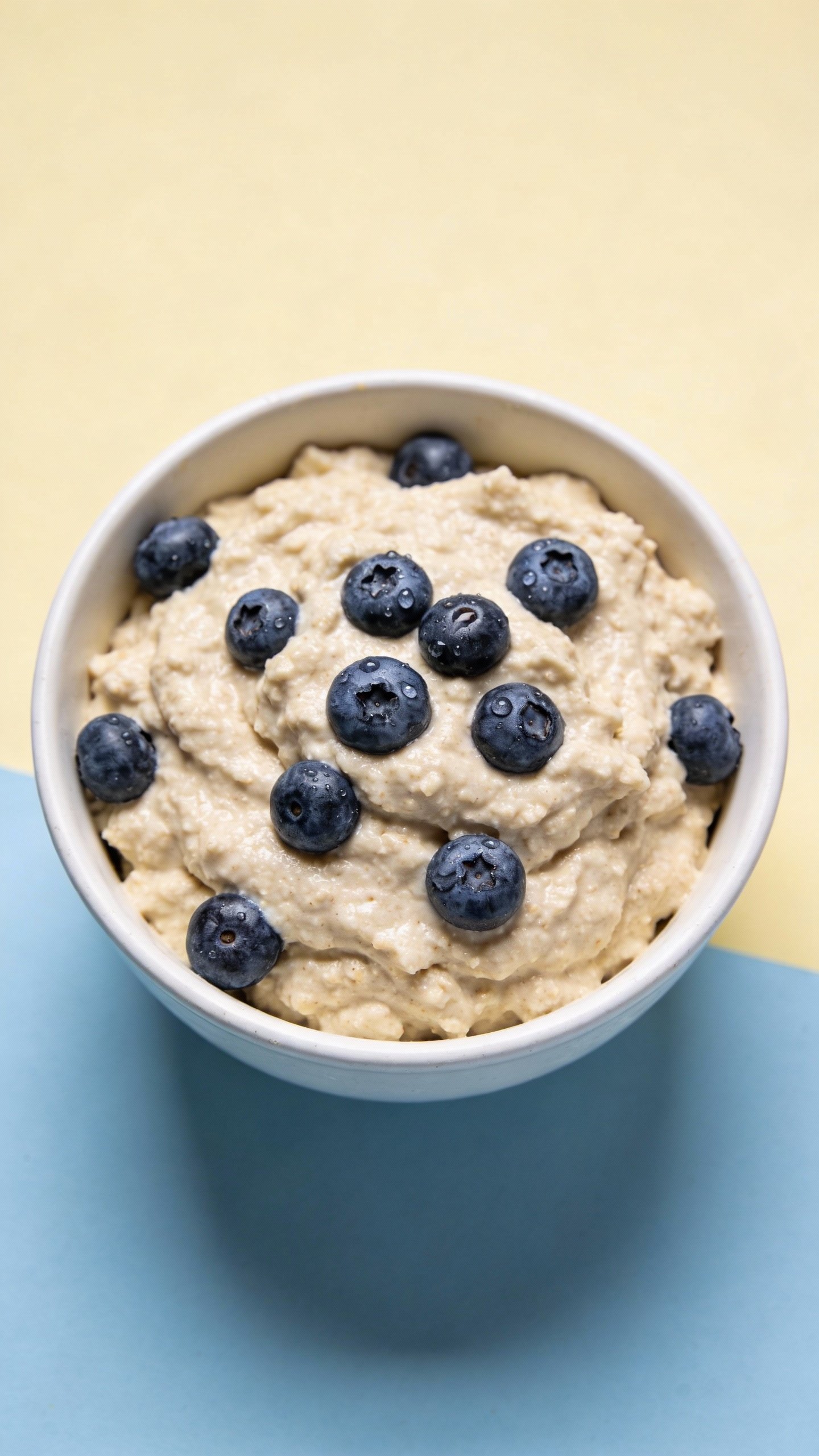 single bowl of almond flour batter with blueberries, overhead shot