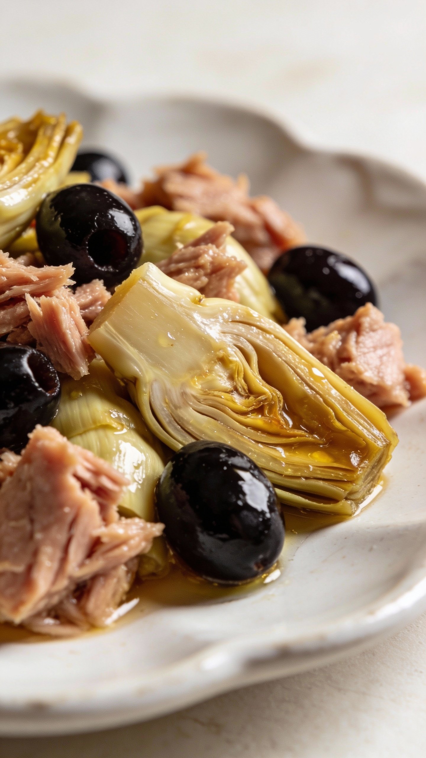Closeup tuna antipasto salad with marinated artichokes, olives