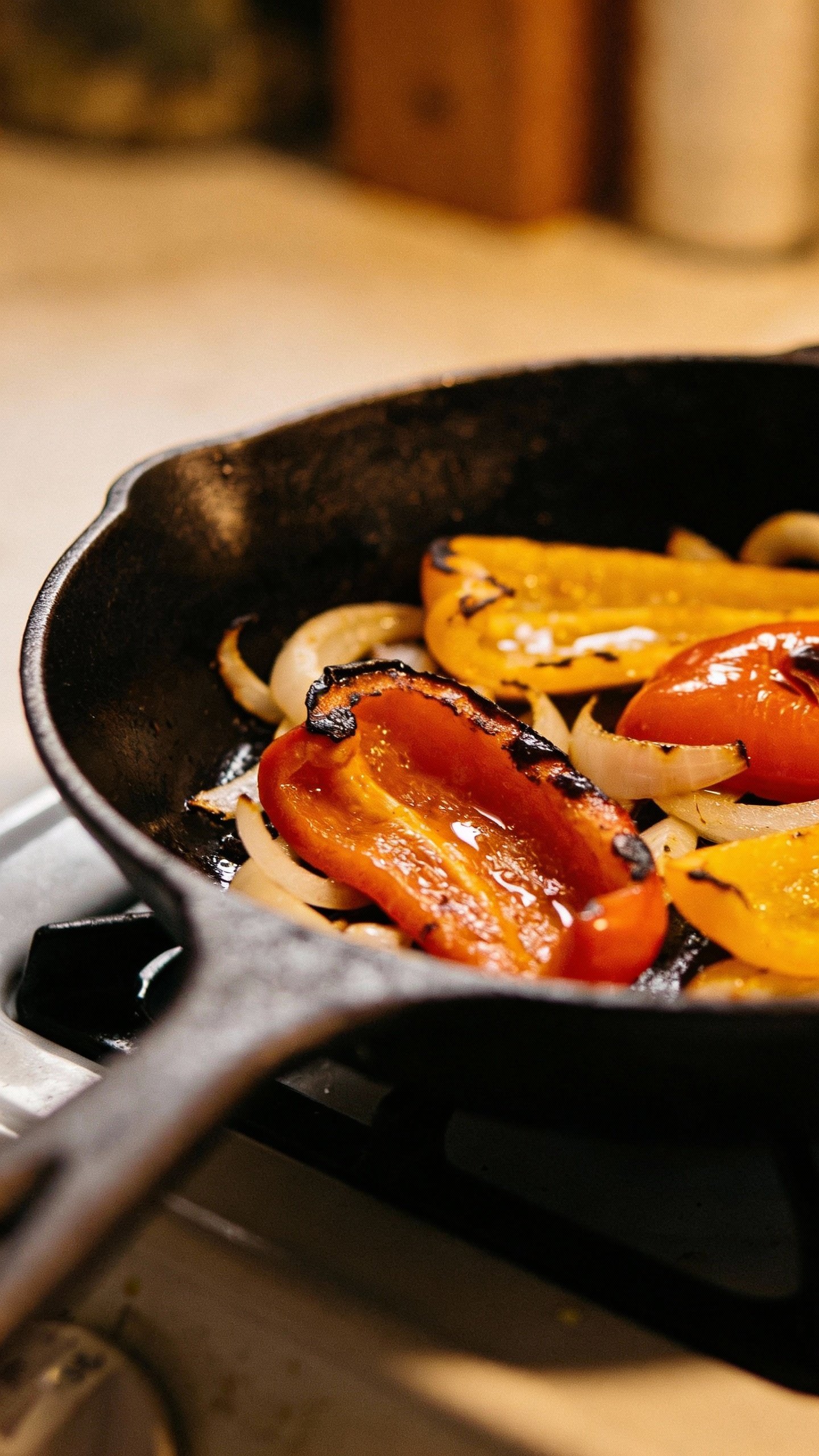 single cast-iron seared peppers and onions, glossy closeup