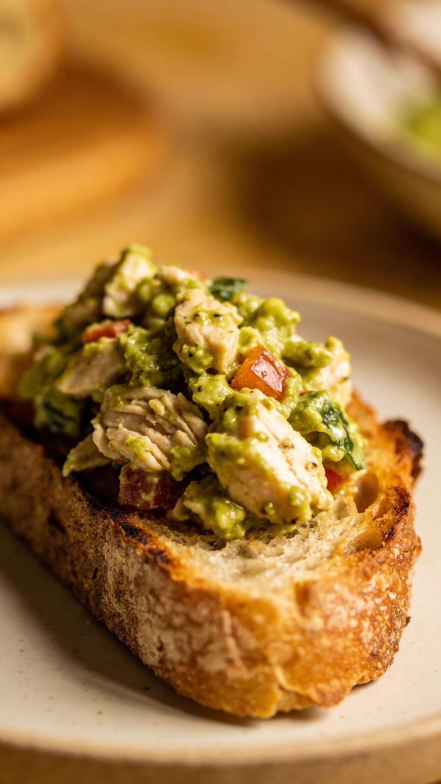 single toasted sourdough topped with pesto chicken salad