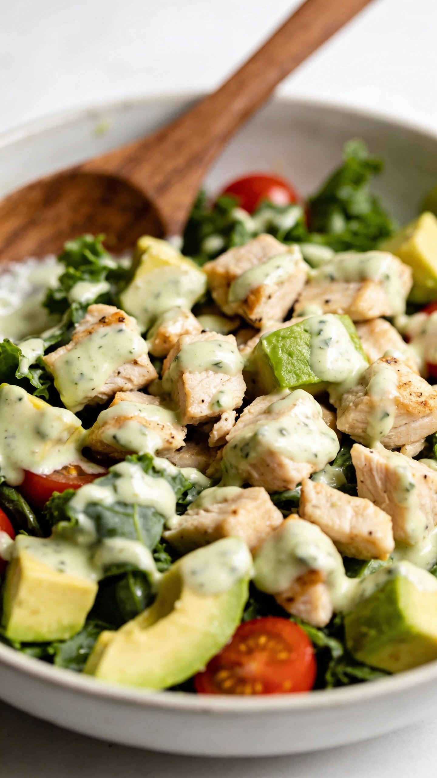 closeup bowl of avocado ranch chicken salad, white backdrop