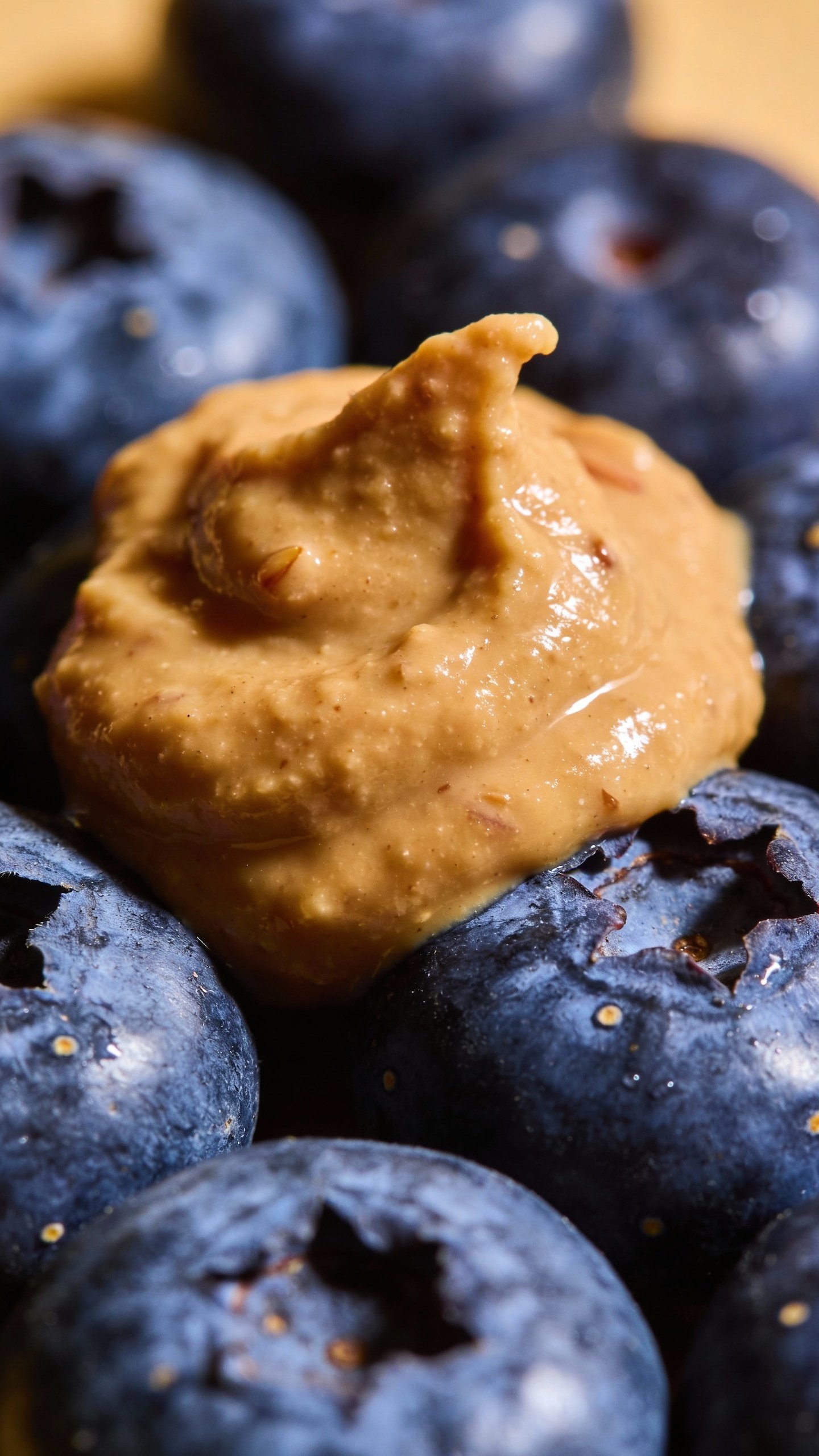 dollop of almond butter on blueberries, macro food shot