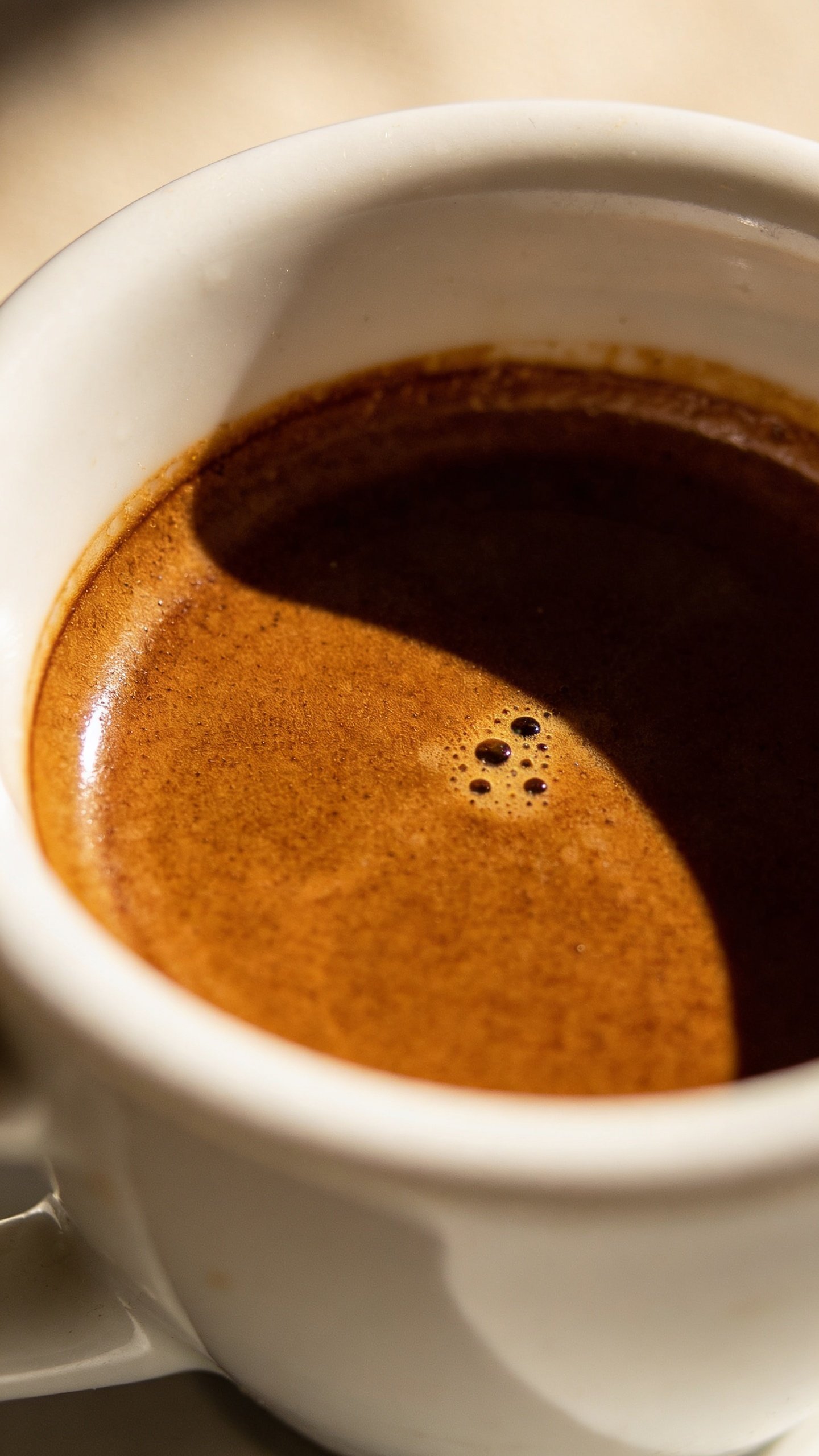 single espresso shot in demitasse, crema visible, soft morning light