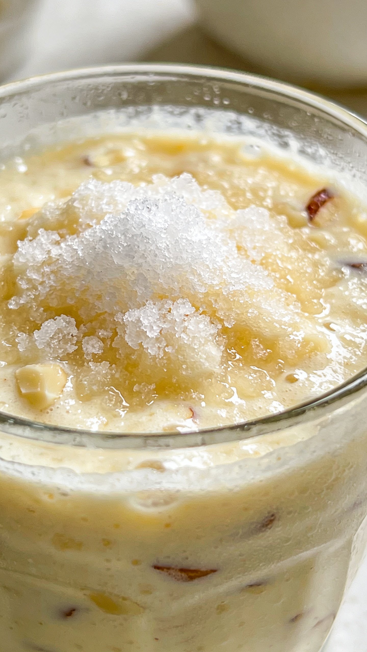 frosty Almond Joy breakfast smoothie in clear glass, closeup