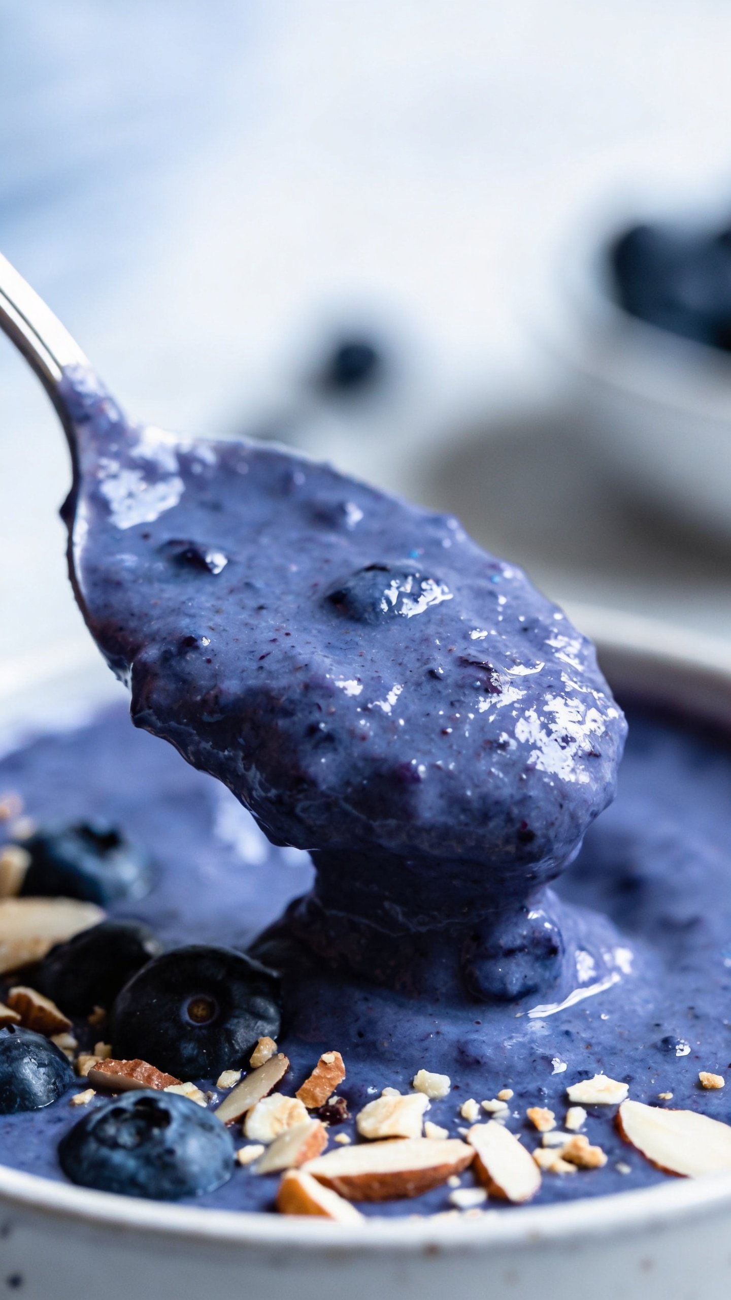 spoonful of thick blueberry almond smoothie, glossy texture