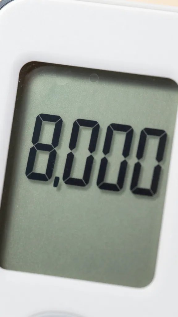 closeup of a digital step counter showing 8,000 steps
